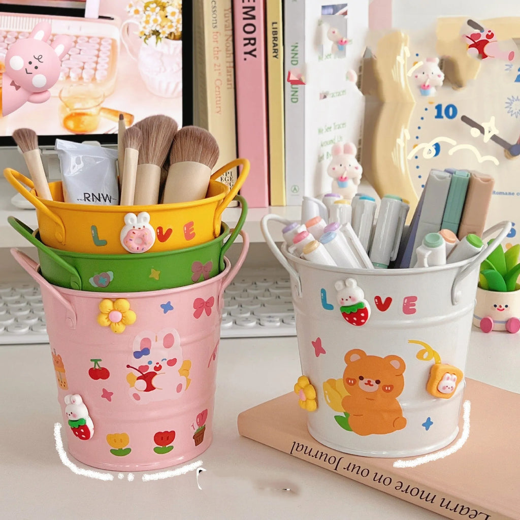 Round metal pen holder in choice of colours with optional decorative sticker patches on a desk.