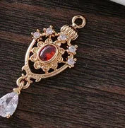 Small gold electroplated copper pendant with hollow crown water drop design and micro-inlaid zircon stones.
