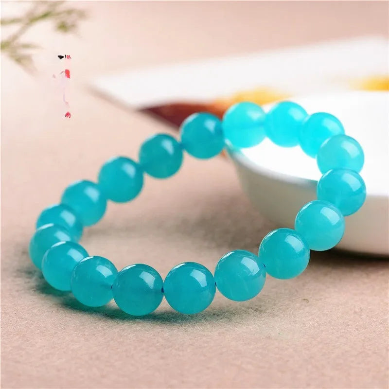 Grade 7A Amazonite natural stone scattered beads arranged on a bracelet, showing blue-green colour and polished finish.