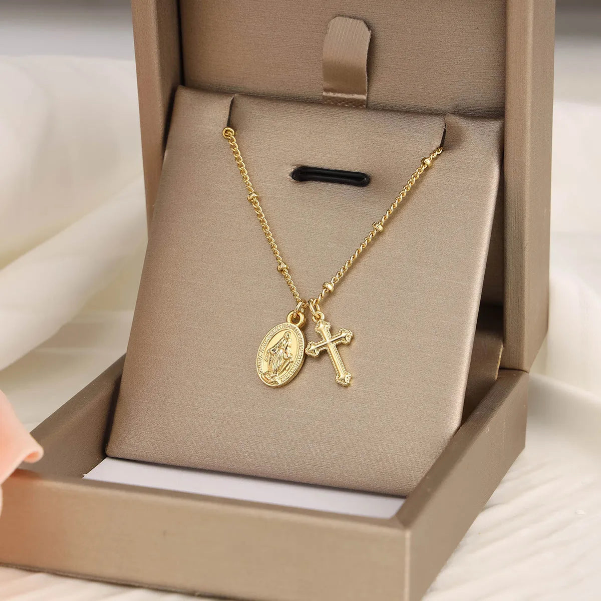 Gold Virgin Mary cross necklace with geometric design on chain