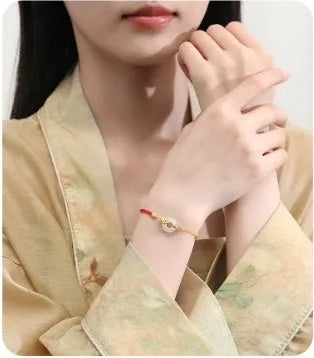 Gold electroplated 925 sterling silver bracelet with red rope and peace buckle featuring koi fish design