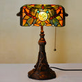 Tiffany style table lamp with coloured stained glass shade on a resin base.