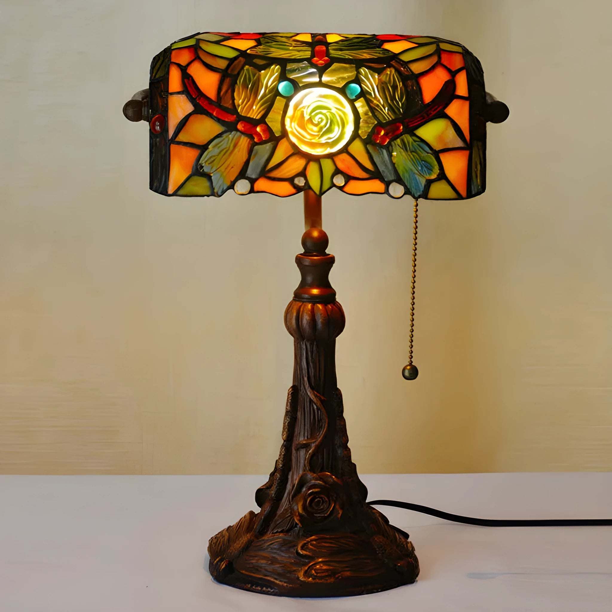 Tiffany style table lamp with coloured stained glass shade on a resin base.