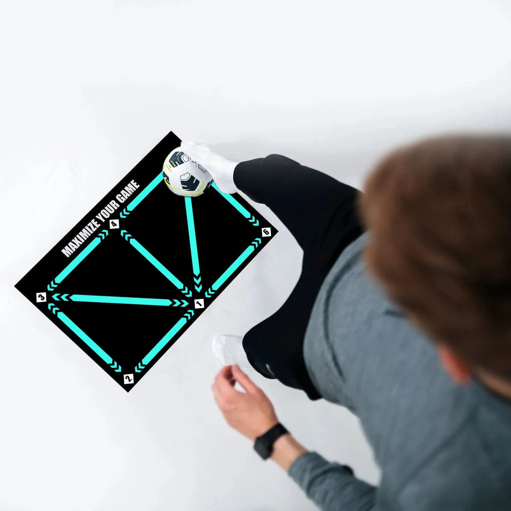Black rectangular football training mat with textured non-slip surface measuring 60cm by 90cm