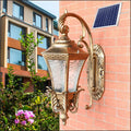 European-style black outdoor wall lamp with solar panel mounted on exterior wall