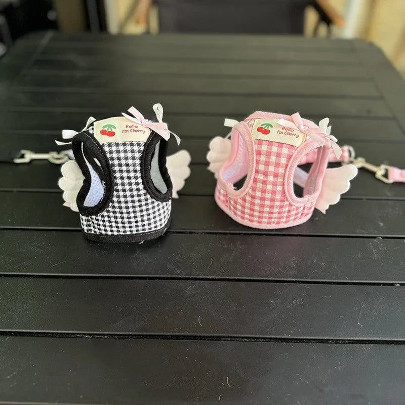 Small dog wearing pink cotton chest and back harness with leash attachment points