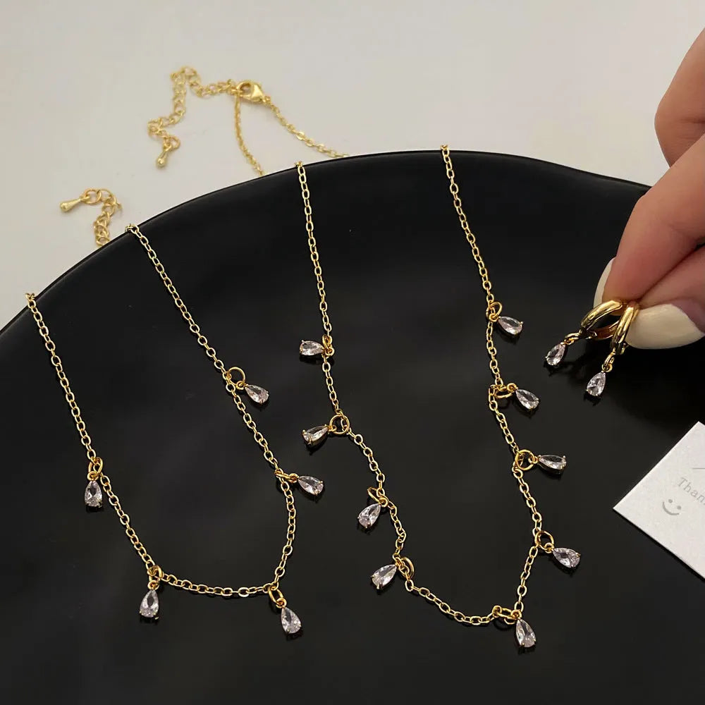 Zircon jewellery set with meteor shower geometric pendant necklace, matching earrings, and anklet