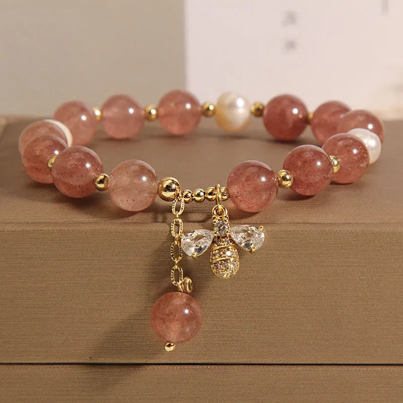 Women's bracelet with strawberry quartz stones, freshwater pearls, and zircon accents on an alloy chain.