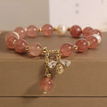 Women's bracelet with strawberry quartz stones, freshwater pearls, and zircon accents on an alloy chain.