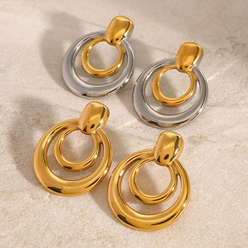 Gold tone geometric round stud earrings with hollow double-layer design on titanium steel backing