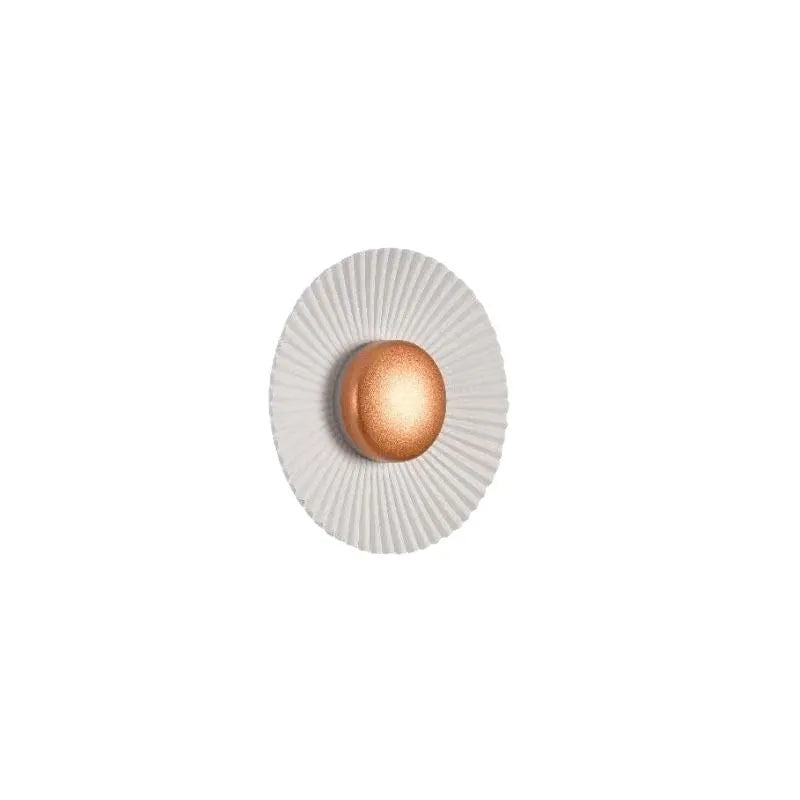 Round wall lamp with aluminium shade in a two-tone white and gold colour combination, mounted on a plain wall.