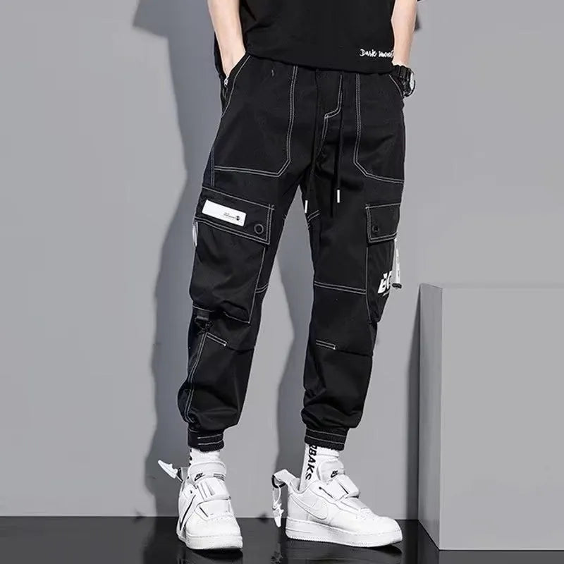 Men's loose fit solid colour polyester trousers in gray, front view, for casual autumn wear