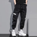 Men's loose fit solid colour polyester trousers in gray, front view, for casual autumn wear