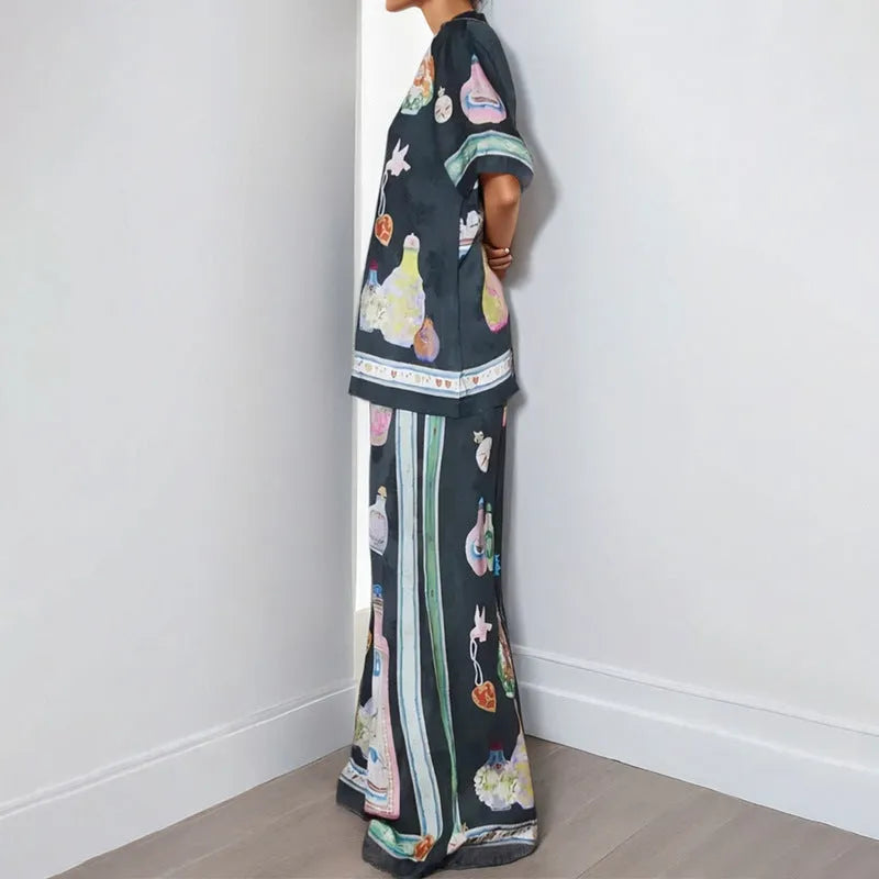 Black women's casual set with cartoon print, featuring a cardigan and matching trousers.