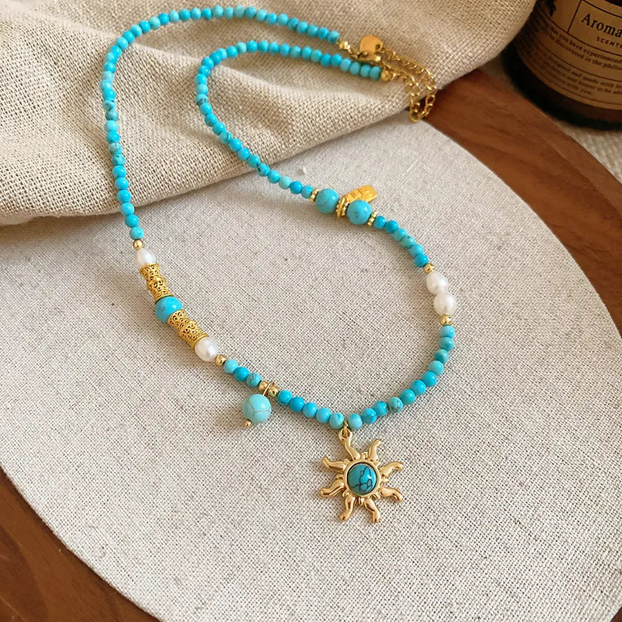 Freshwater pearl necklace with stone sun pendant, French court style, blue and golden-blue-pink colours