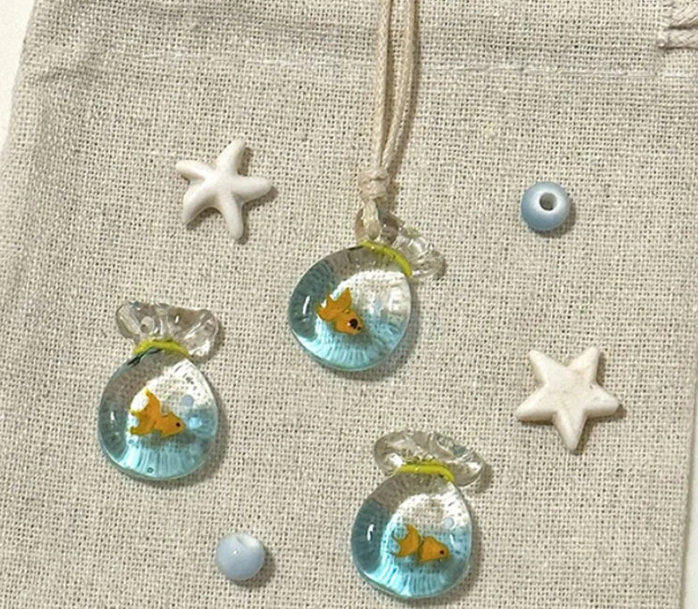 Women's skirt and joker charm pendant necklace with coloured glass on a cotton linen clavicle chain.