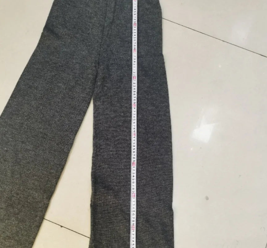 Women's acrylic sweater suit with side-slit top and trousers in dark grey.