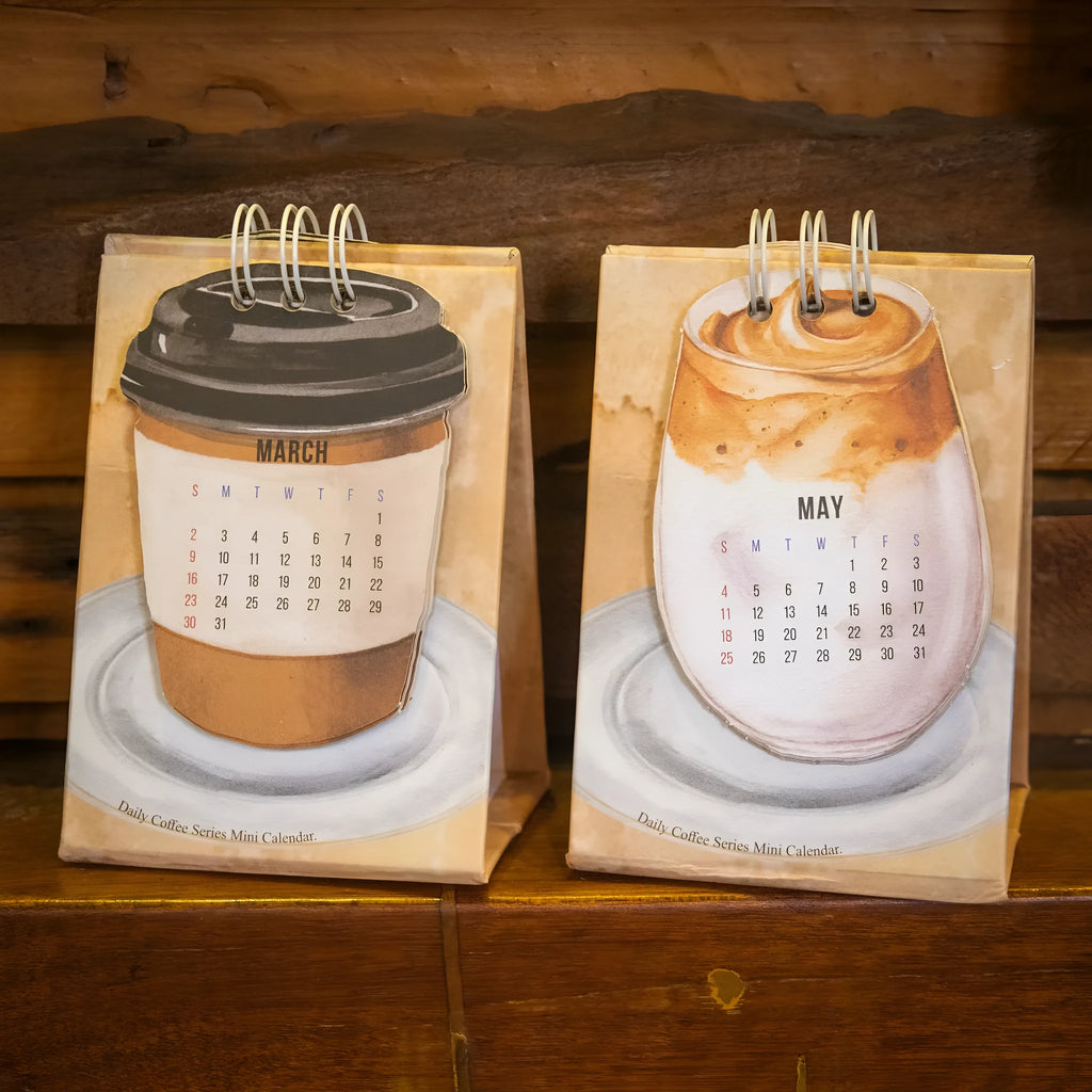 Mini 2025 desk calendar with simple modern design on a desk.