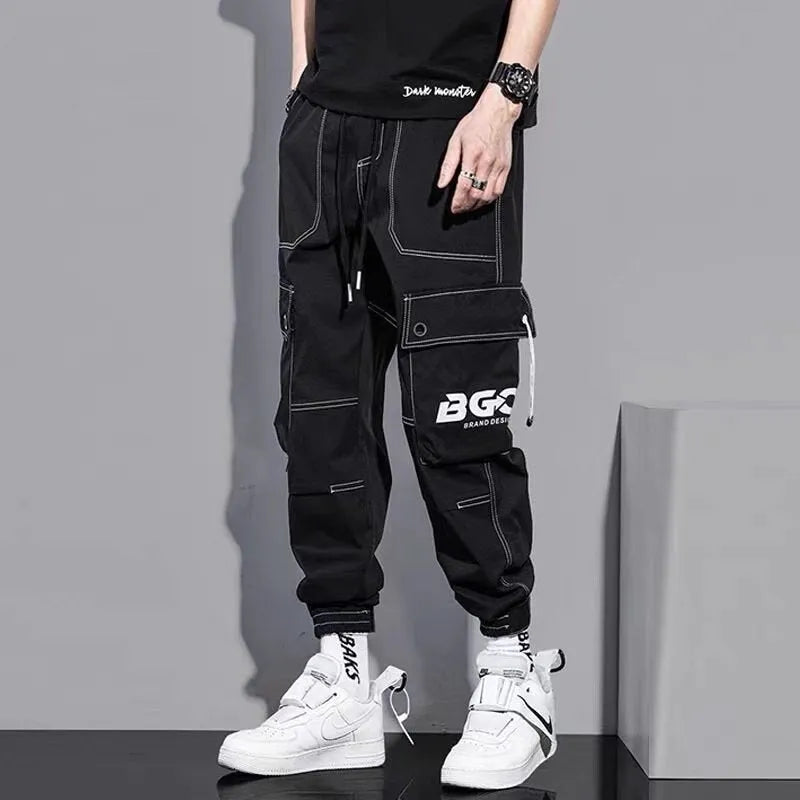 Men's loose fit solid colour polyester trousers in gray, front view, for casual autumn wear