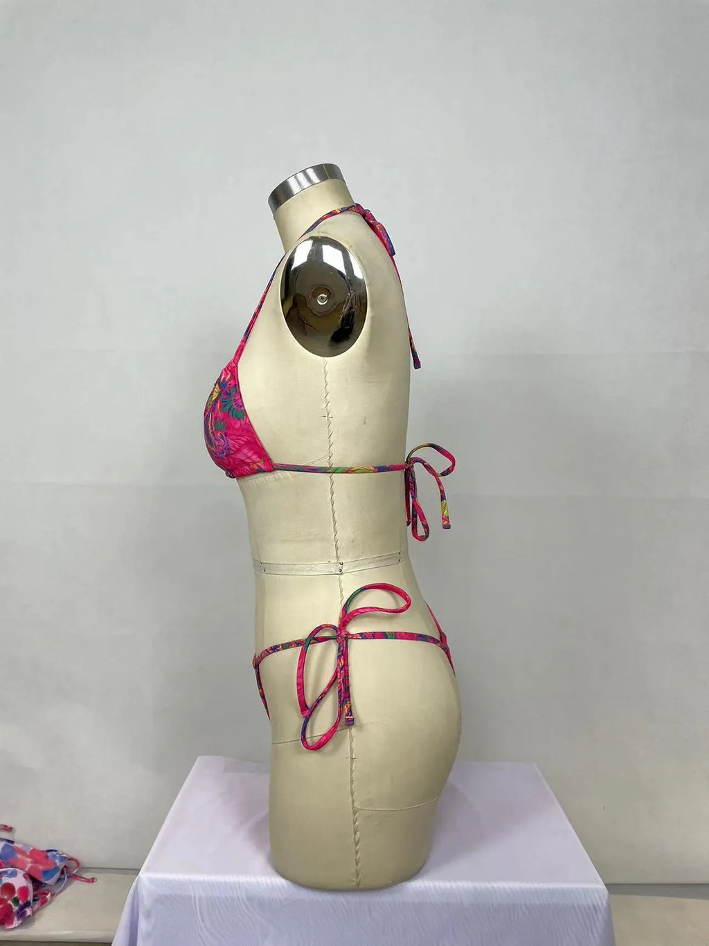 Women's pink printed bikini two-piece set with triangle top and briefs on display