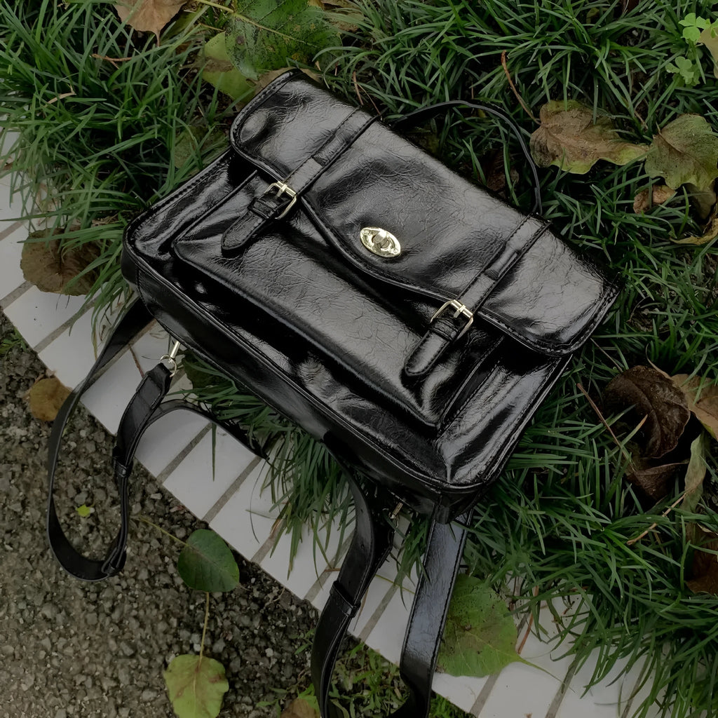 Black PU leather women's messenger bag with adjustable shoulder strap.