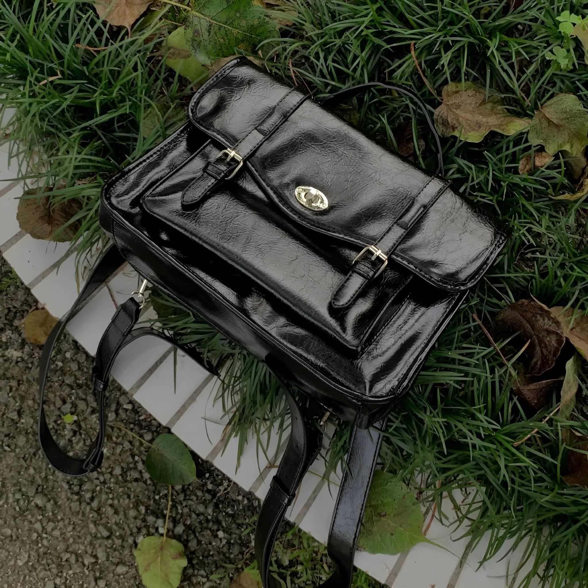 Black PU leather women's messenger bag with adjustable shoulder strap.