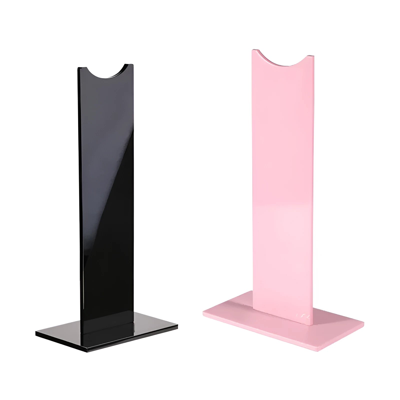 Pink and black foldable head-mounted headset stand with a non-slip silicone base on a desk.