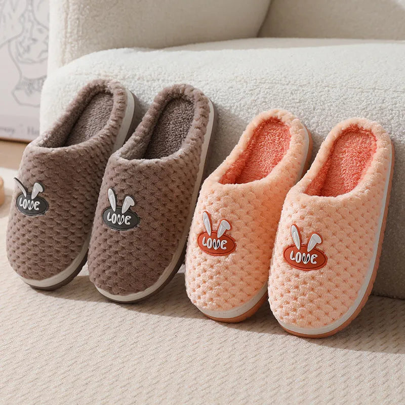 Women's rabbit and plaid print artificial fur slippers with thick rubber sole.