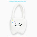 White plush tote bag with cute teeth pattern, showing crossbody strap and zipper closure.