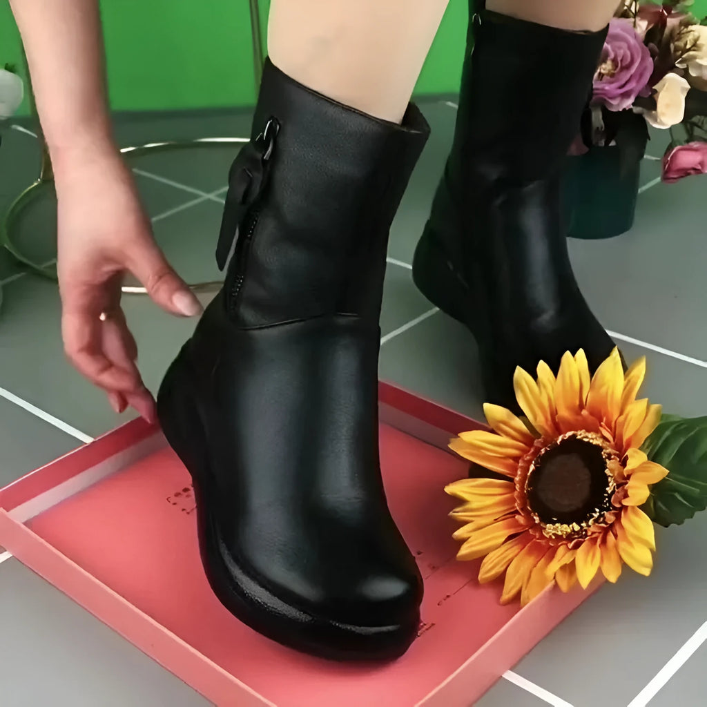 Retro British style flat boots with cowhide upper, side zipper, and metal decorative accents on a low tube silhouette.