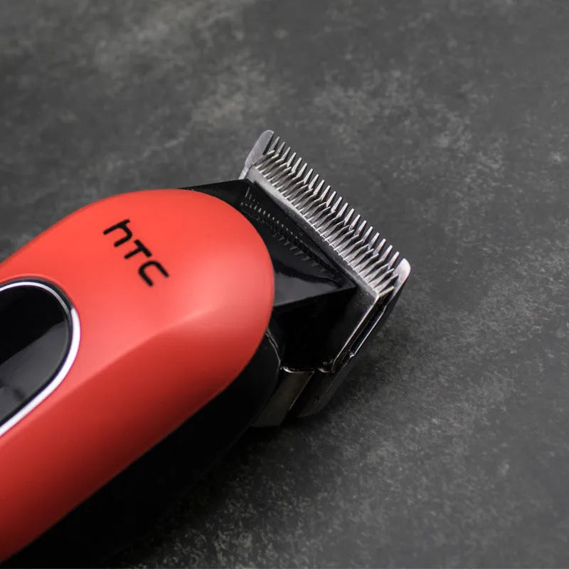 Professional waterproof electric hair clipper with brushless motor, shown in black, red, or white.
