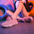 Women's white casual sports shoes with woven upper, thick rubber sole, and front strap fastening