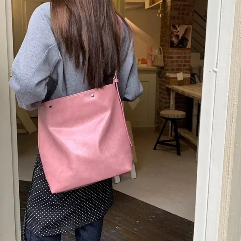 Pink or brown corduroy one-shoulder commuter bag showing dimensions
