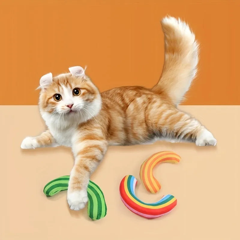 Green, rainbow, and yellow striped plush cat pillow with attached noise toy, measuring 23cm by 20cm.