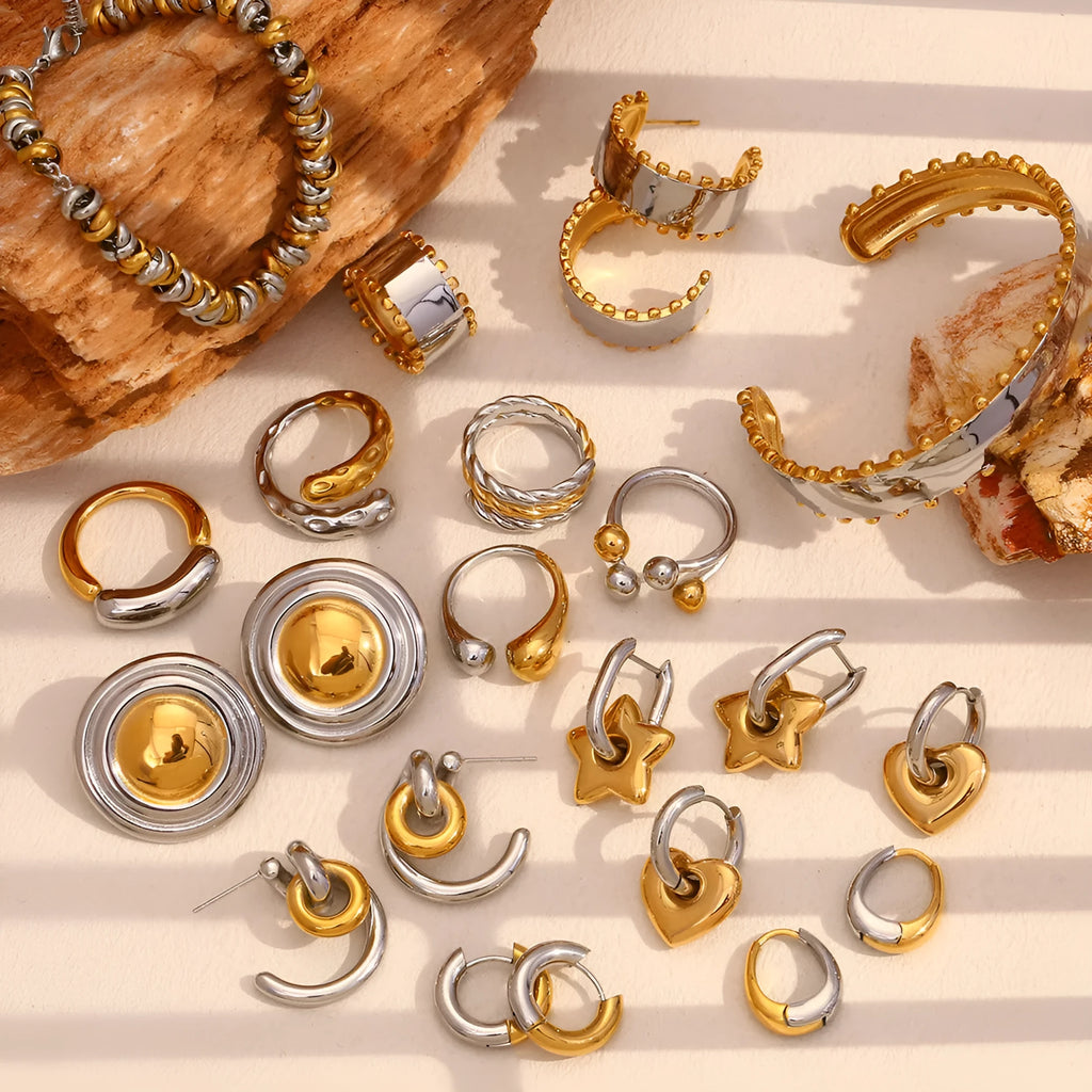 Gold tone electroplated stainless steel jewellery set with geometric shapes including earrings, bracelet and necklace