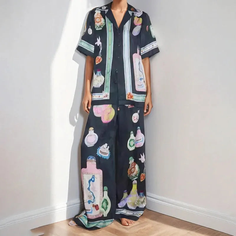 Black women's casual set with cartoon print, featuring a cardigan and matching trousers.