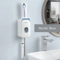 Automatic wall-mounted toothpaste dispenser in blue colour on a bathroom wall.