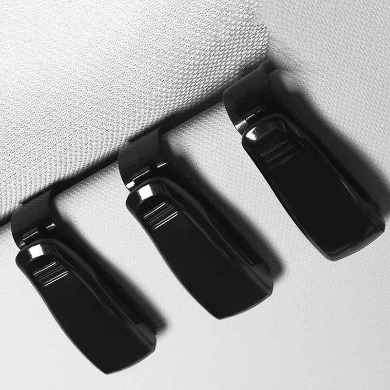 Black plastic car sun visor clip for holding glasses and cards, shown next to a ruler showing 6.5 cm length.