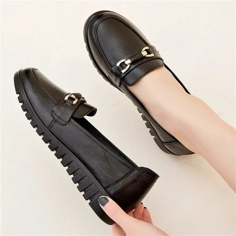 Black women's round-toe pumps with a low flat heel and elastic slip-on design.
