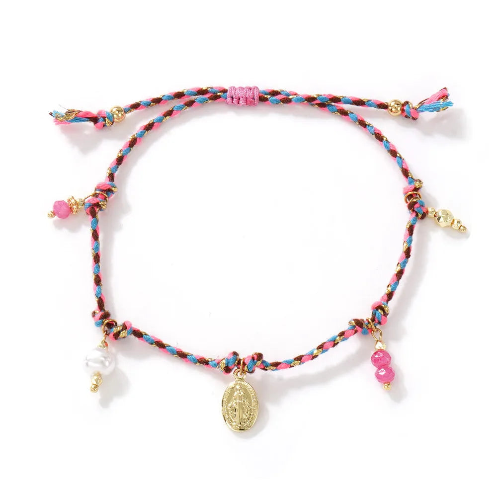 Close-up of a hand-woven ethnic bracelet for women made from colourful braided rope.