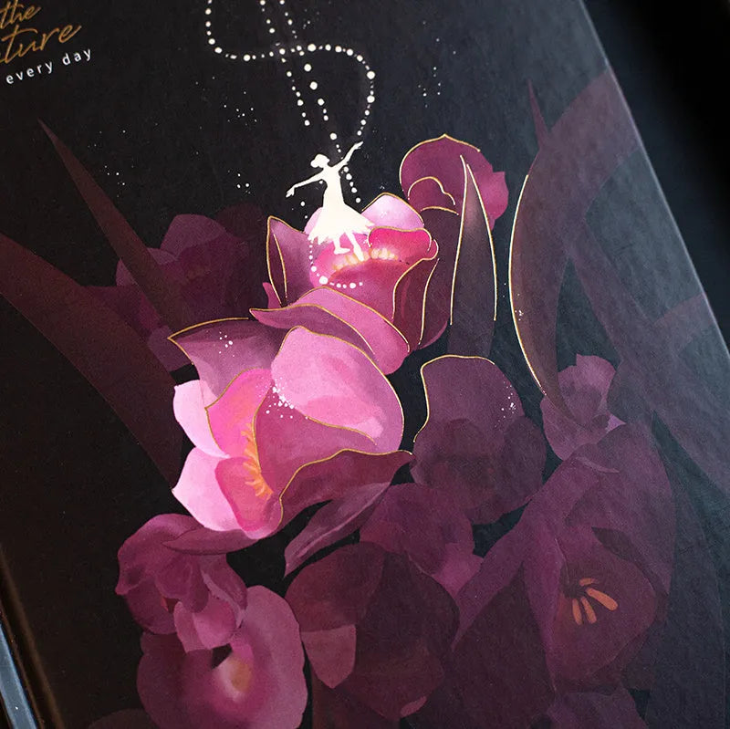 A5 notebook with luminous reflective cover shown in four colours: deep blue, gold, light blue, purple, open to reveal pages with colour illustrations.