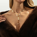 Y-shaped leaf fringe pendant necklace gold tone on white background, copper chain, iron leaf pendant