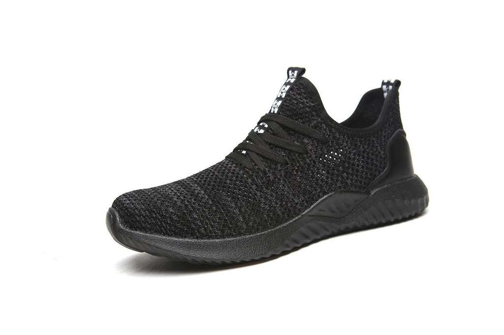 Steel toe cap safety work shoes in black with low-cut design, shown on a work site background.