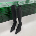 Women's black pointed toe ankle boots with a stiletto heel and a back zipper fastening.