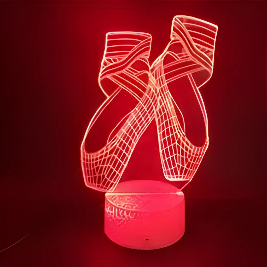 3D laser-etched ballet shoe night light with coloured LEDs on an ABS base, showing remote control.