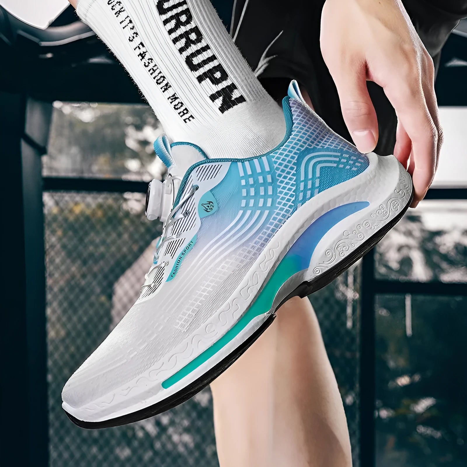 Men's low-top mesh sneaker with a rotating buckle closure on the side, shown in a two-tone colour combination.