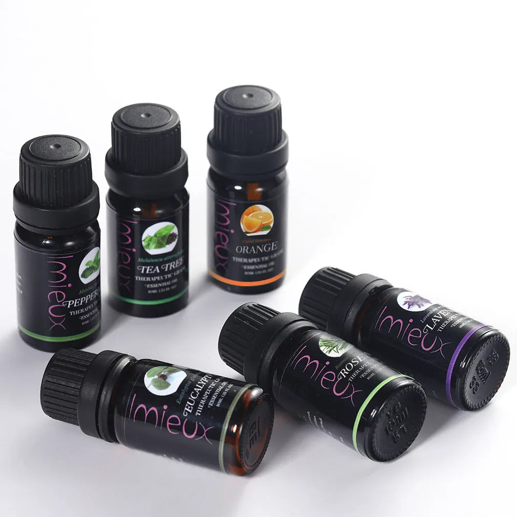 Six 10ml essential oil bottles in a row – tea tree, mint, sweet orange, eucalyptus, rosemary, lavender