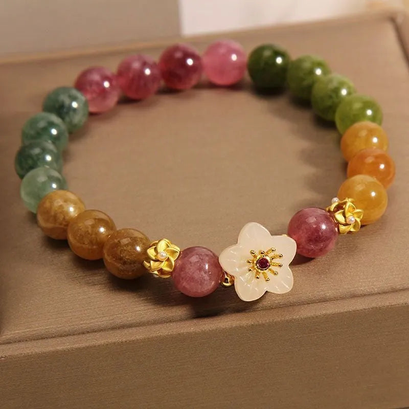 Natural colour tourmaline bracelet with electroplated finish showing geometric shape and delicate flower design