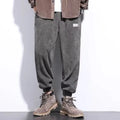 Men's grey ankle-tied straight leg sweatpants laid flat, showing casual sports design.