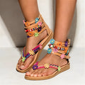 Women's beaded petal flower decoration on ethnic Roman-style flat sandals with artificial PU upper.